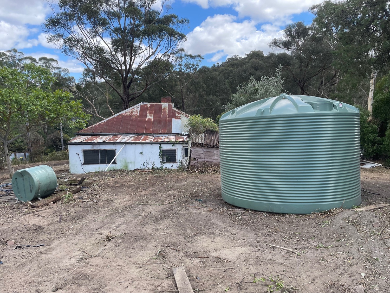 AFTER - A house and a second water tank revealed! This house and its surrounds were entirely obscured by blackberries and other vegetation.&nbsp;