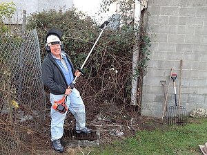 Worker with blackberry removal tools in front of job