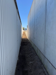 blackberry infestion cleared from between factory walls at Spa Industries Global in Hallam VIC
